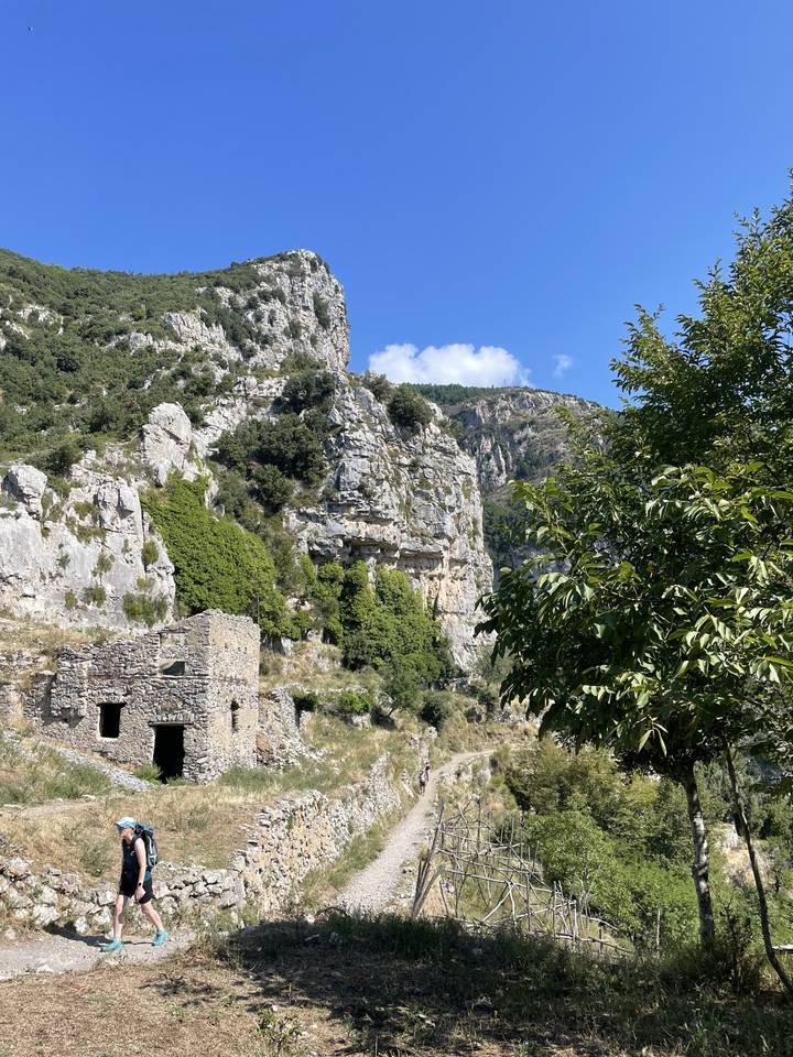 A rocky landscape with a path and a person on the left side.