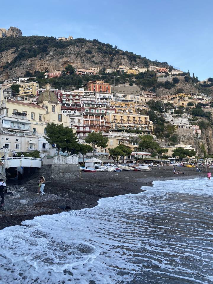 Coastal town with colourful buildings along a beach.