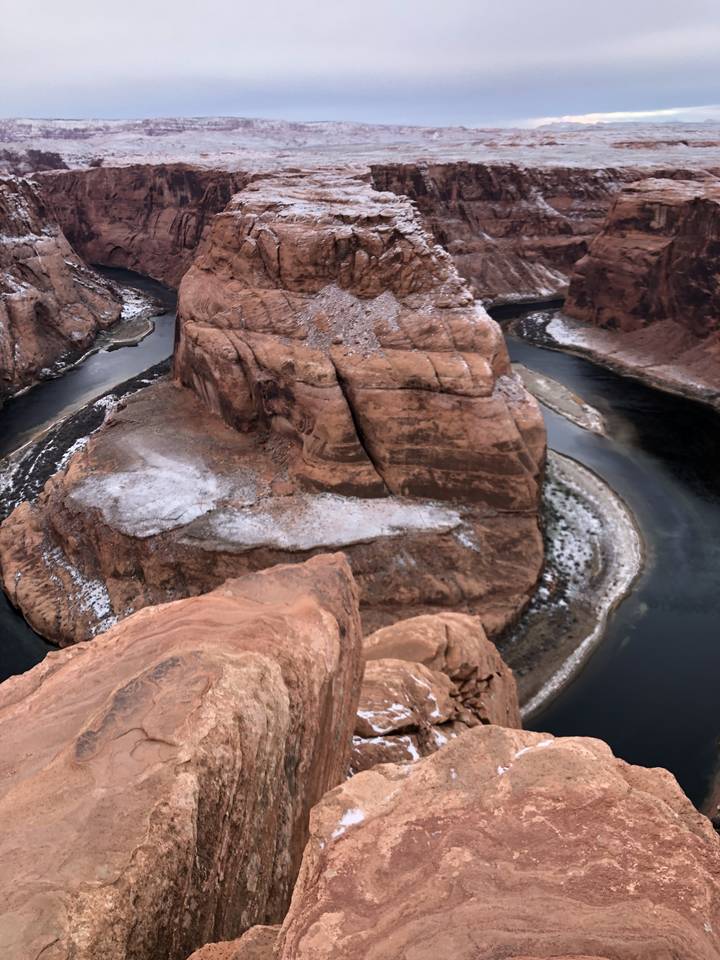 Aerial view of a canyon landscape with a river flowing through.