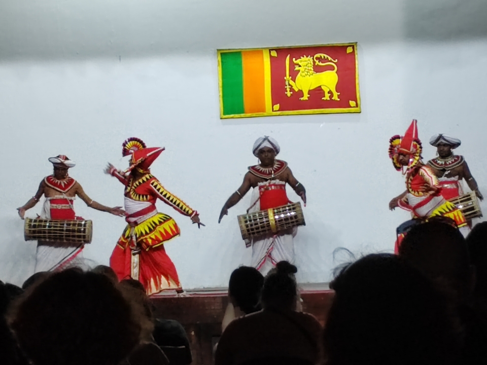 Performance de danse culturelle avec plusieurs interprètes sur scène.