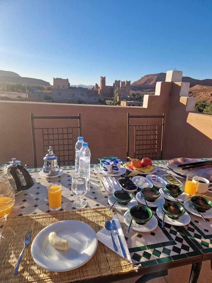 Breakfast setup on a terrace with a view of the landscape.