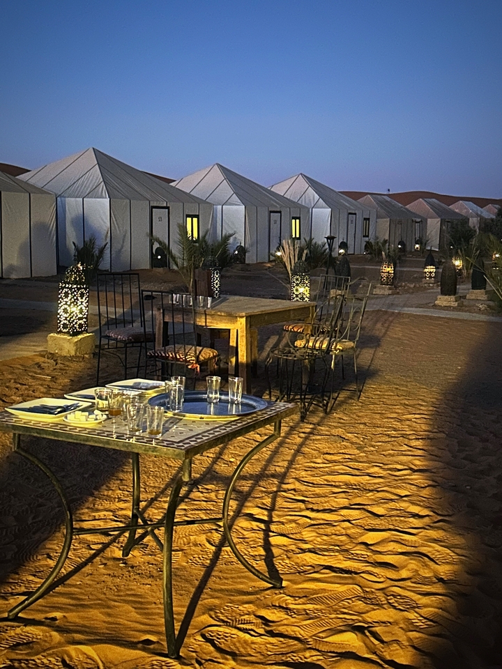 Night view of a desert camp setup.