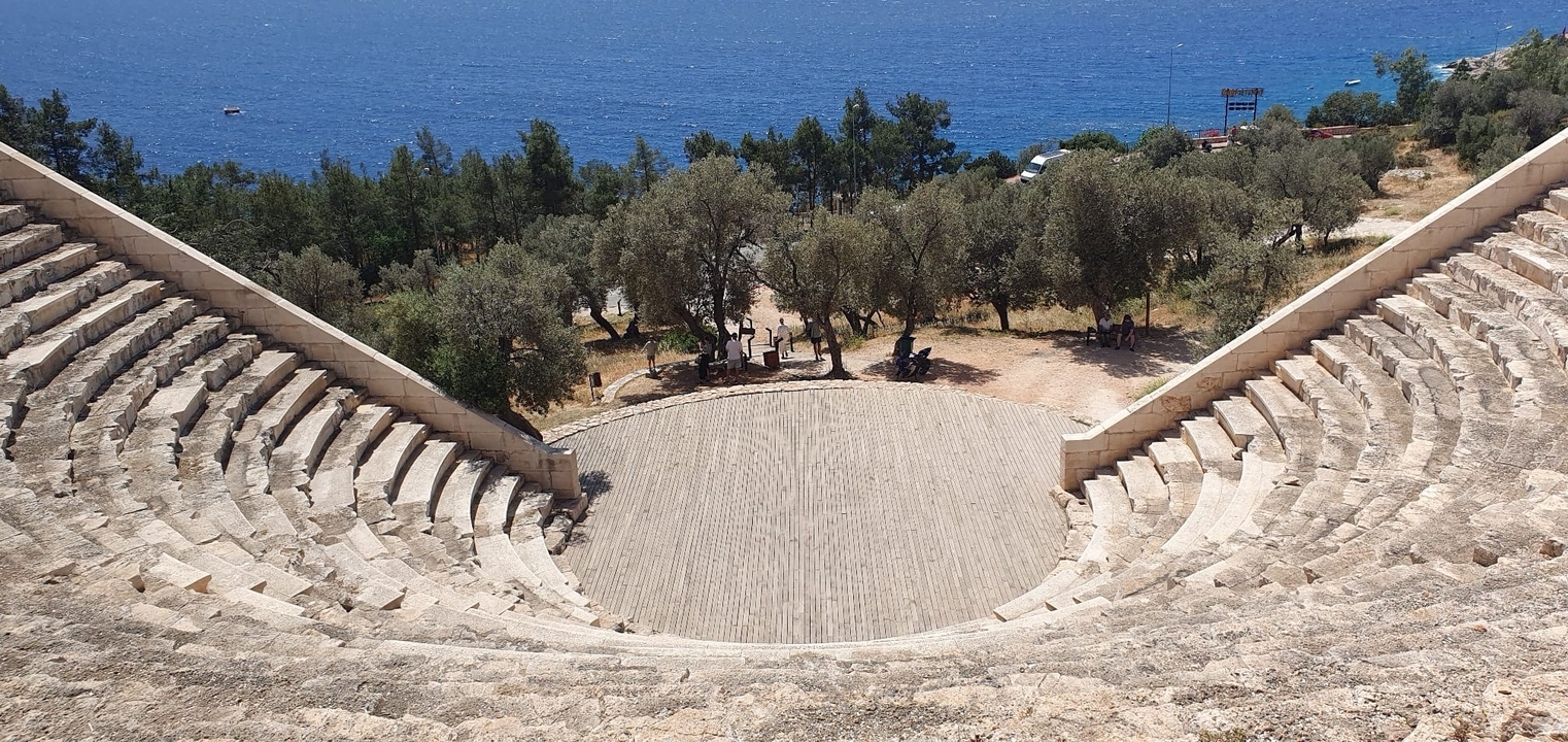 Ancient amphitheater with view towards the sea.