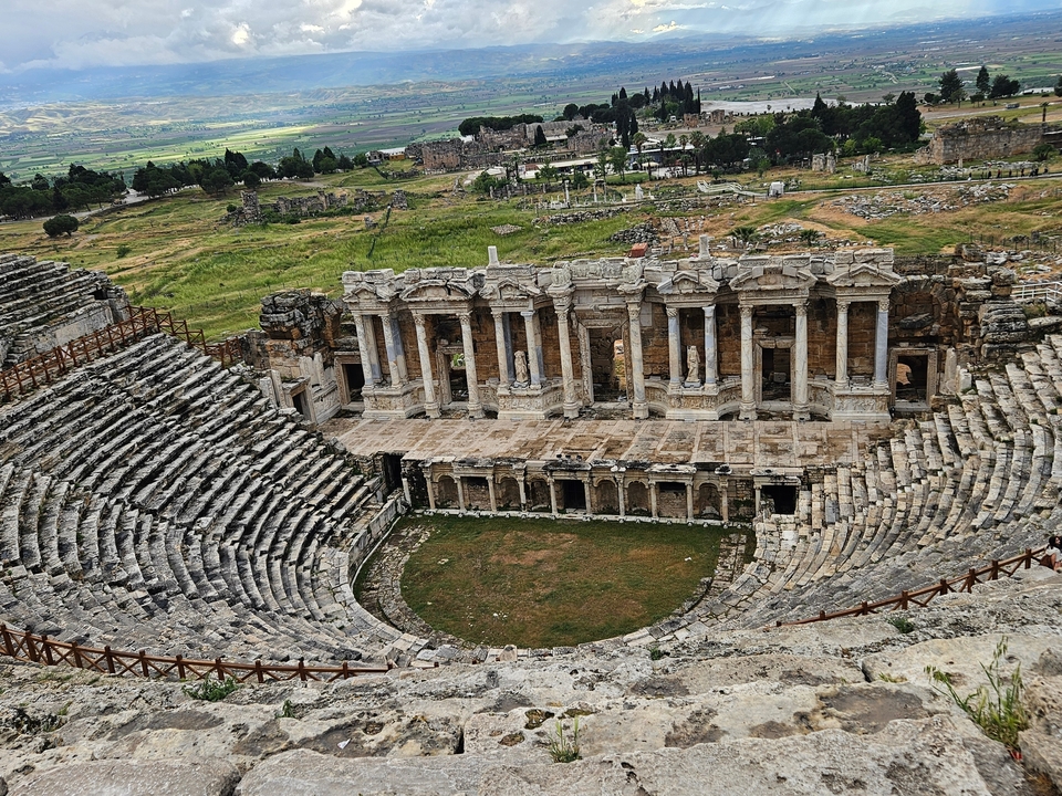 Ruins of an ancient amphitheater with intricate facade.