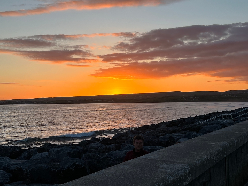 Sunset over a rocky coastline.