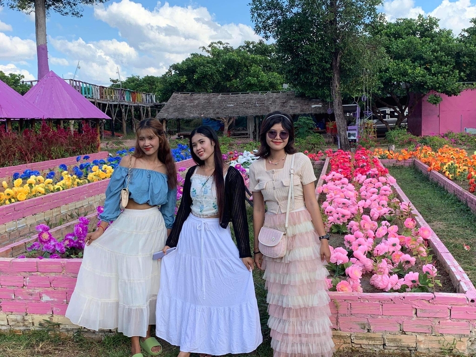 Three women in a colorful garden setting