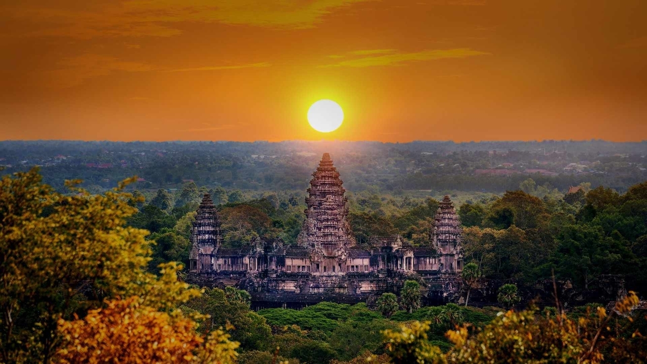 Sunset view of Angkor Wat amidst foliage