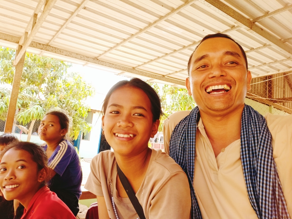 Group of smiling people posing together.