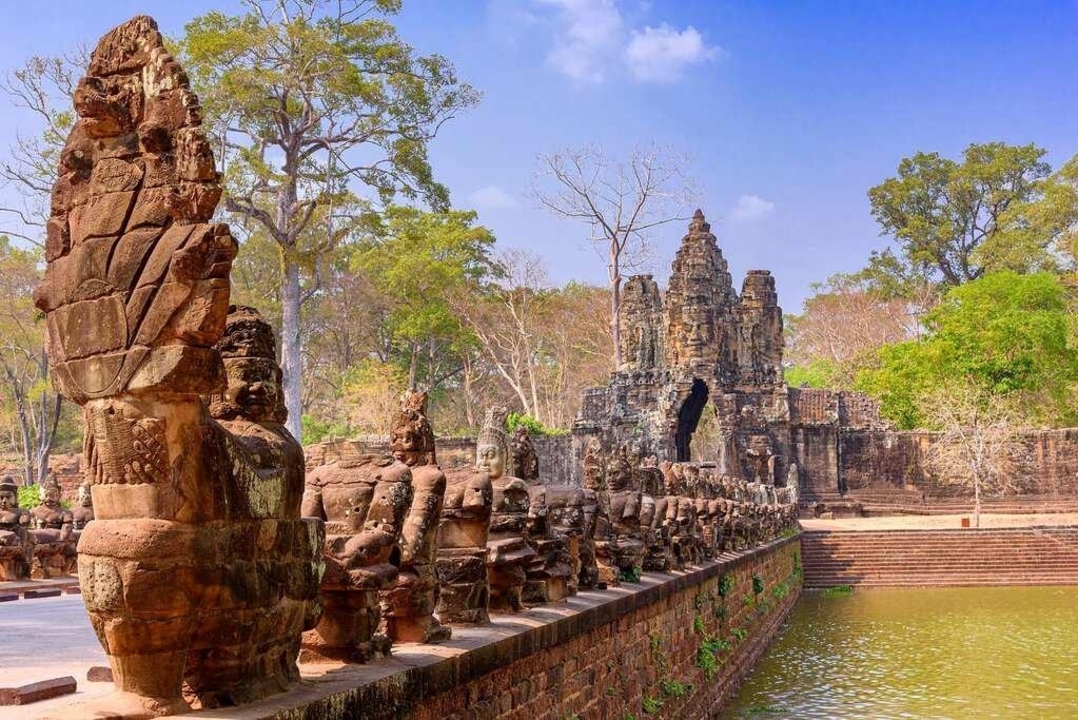 Angkor Thom entrance with statues lining the path.