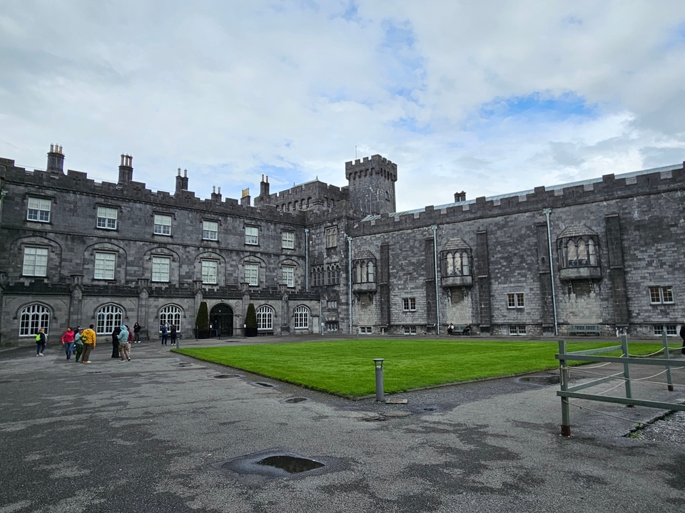 Historic castle with people walking around.