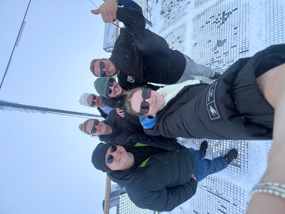 Group selfie in snowy conditions.
