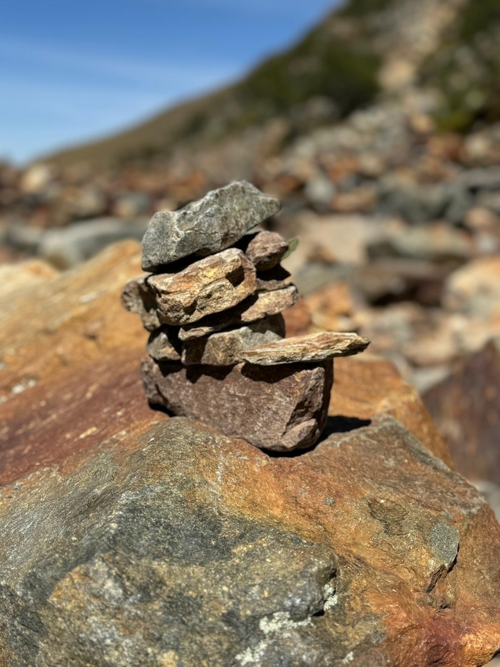 Stacked stones in a scenic natural setting.