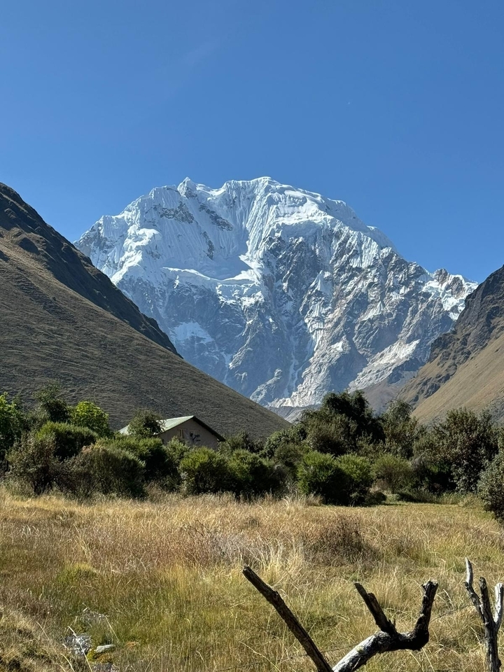 Imposing snowy peak viewed from a lush valley.