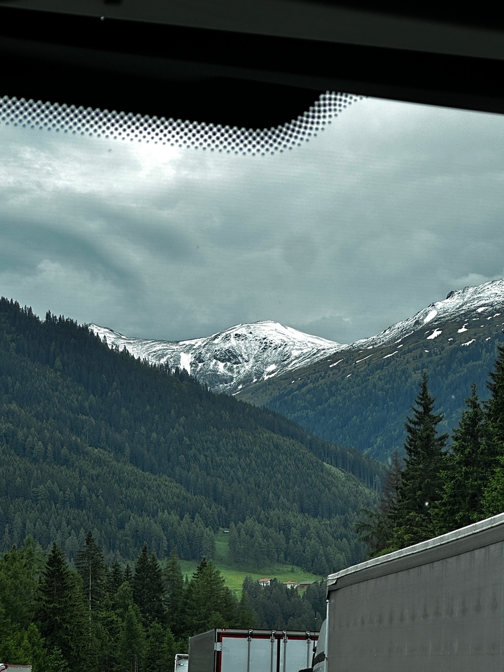 Snow-capped mountains under a cloudy sky