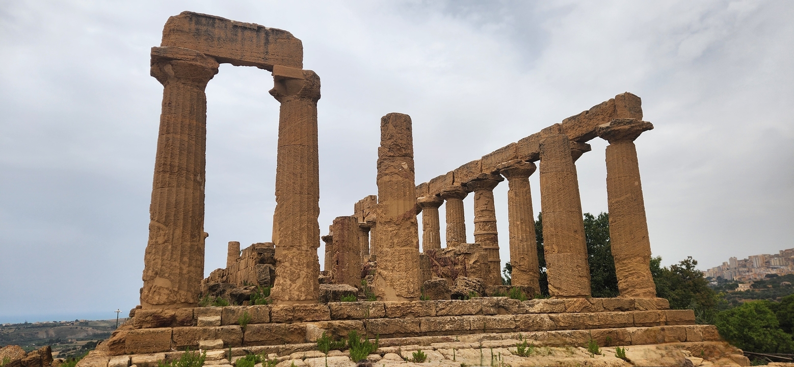 Ruins of ancient columns with overcast sky.