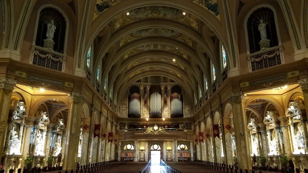 Intricate architecture of a cathedral aisle.