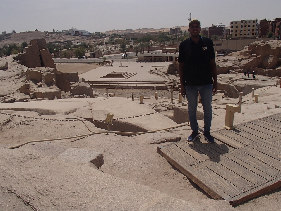 Stone ruins on a sunny day with a person partly visible.