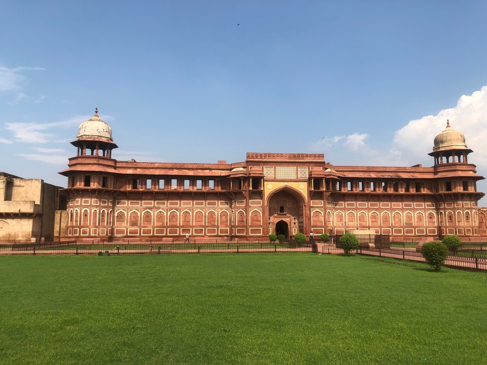 Architecture indienne classique avec grès rouge et pelouse verte.