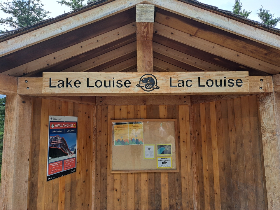 Wooden information board sign for Lake Louise.