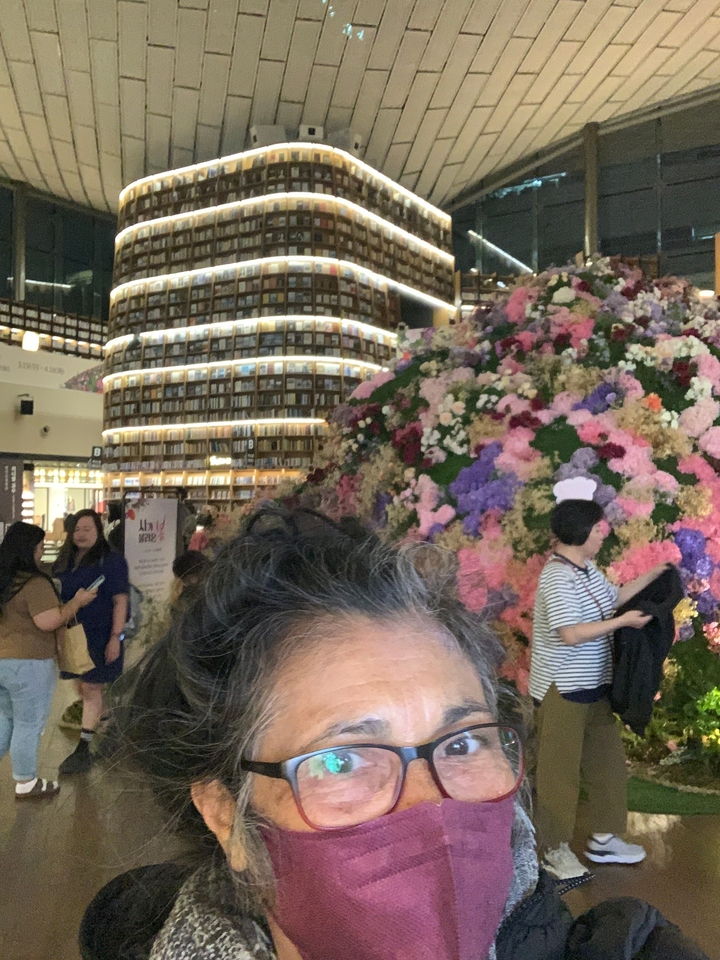 Personne devant un grand étalage floral dans une librairie.