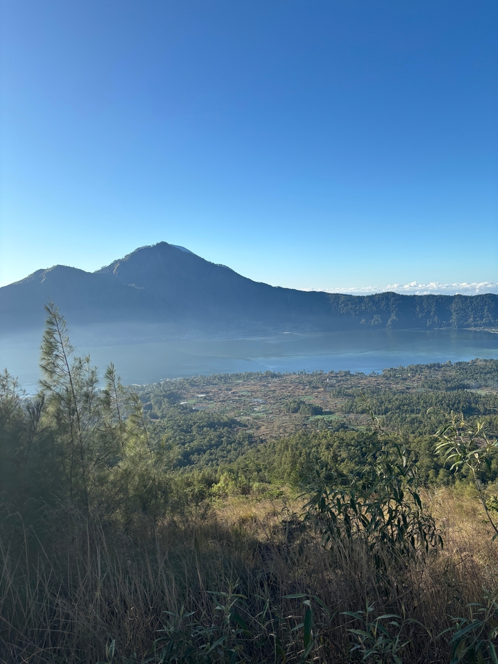 View of a mountain and a lake with forested surroundings.