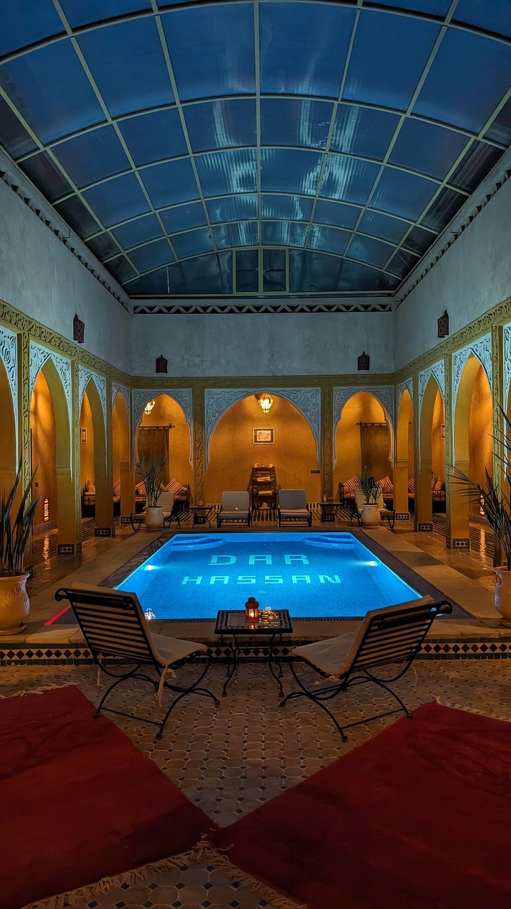 Piscine intérieure avec arches et éclairage.