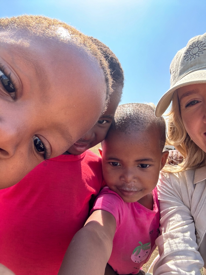 Close-up of children and adult posing for a selfie.