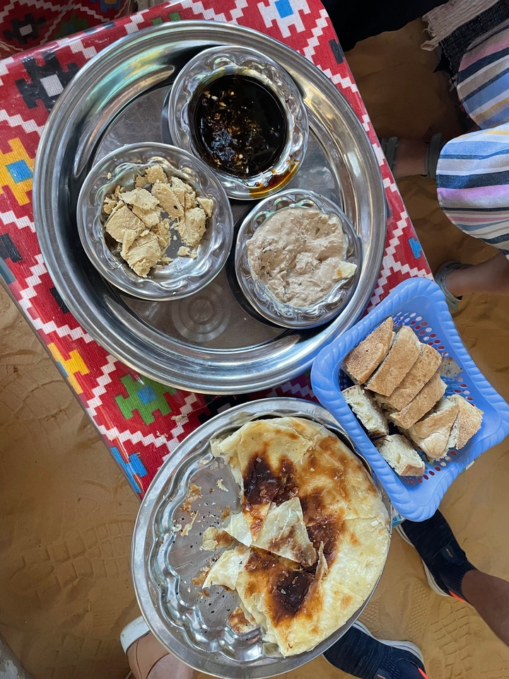 Traditional meal with flatbread and dips.
