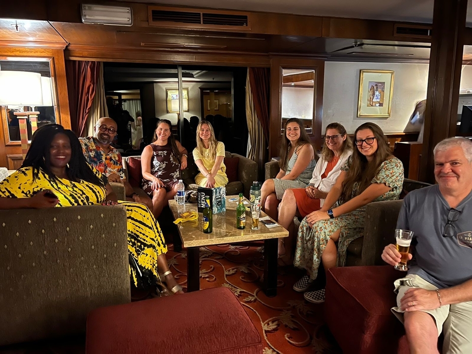 A group of people relaxing indoors with drinks.