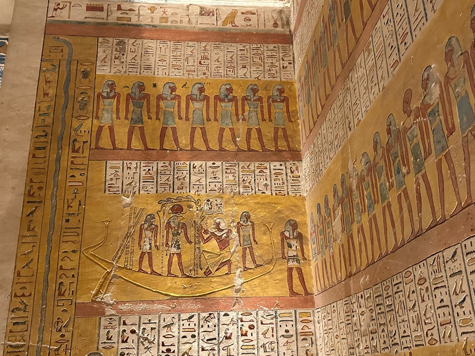 Ancient Egyptian wall paintings with hieroglyphs.