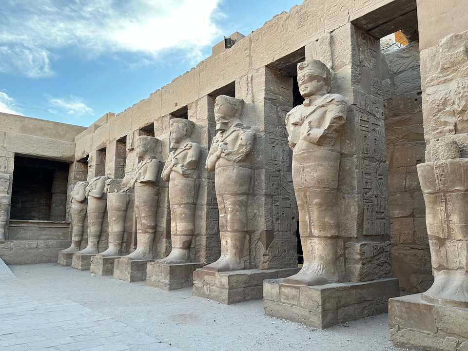 Row of ancient statues in an Egyptian temple.