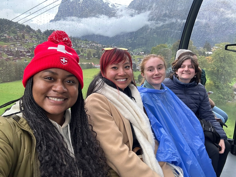 Group of people in a cable car on a rainy day.