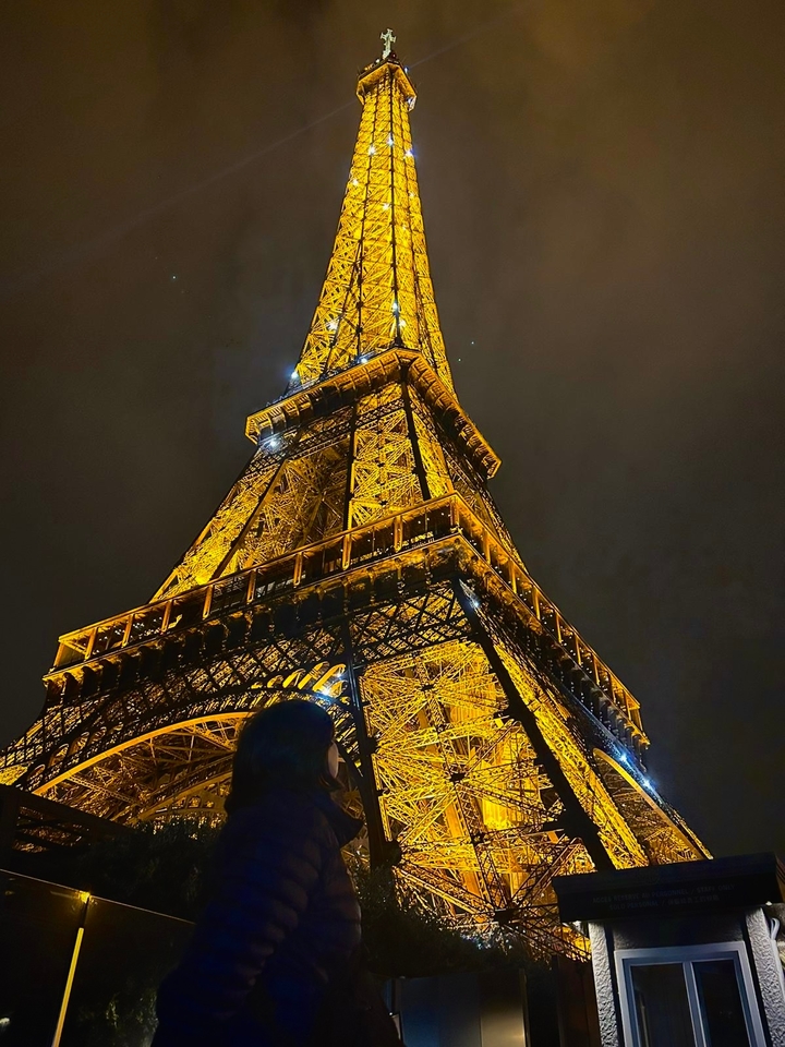 Illuminated Eiffel Tower against the night sky.