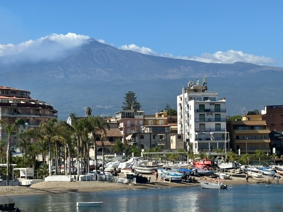 Cityscape with Mount Etna in the background.