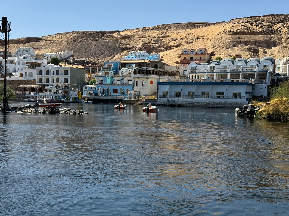 Colorful buildings along a waterfront with small boats