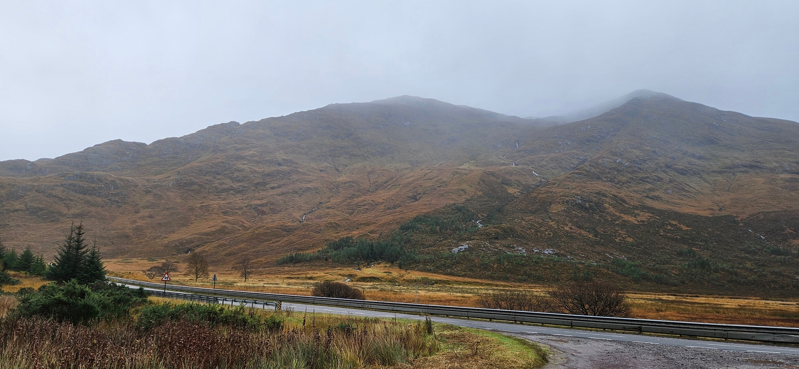 Misty mountain with a road in the foreground.