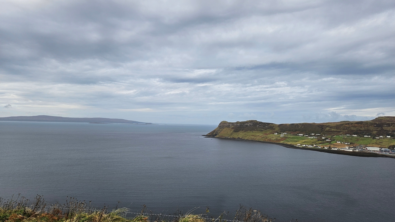 Coastal view with cliffs and cloudy sky.