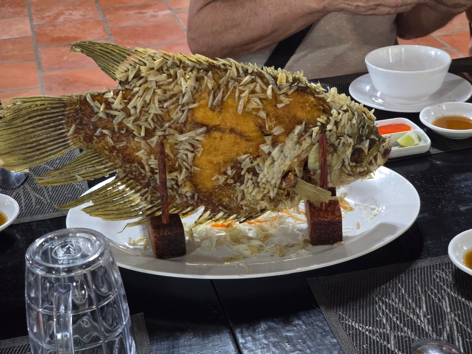 Traditional Vietnamese dish of a whole fish on a table.