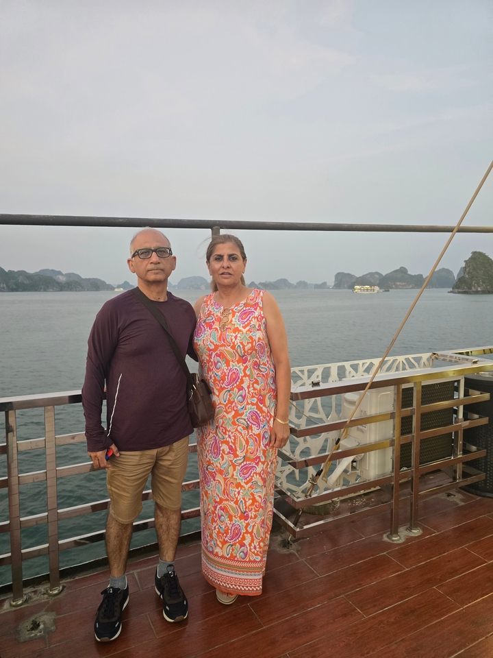 Couple standing with Halong Bay in the background.