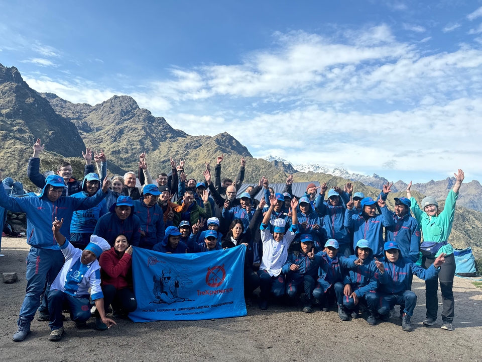 Large group of people in matching attire in a mountainous area.