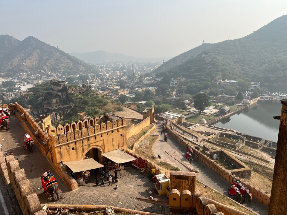 Aerial view of fort and city with surrounding hills.