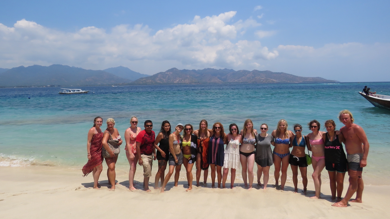 Group of people posing on a tropical beach
