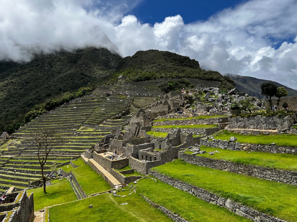 Iconic terraced structure of Machu Picchu with mountains in the background.