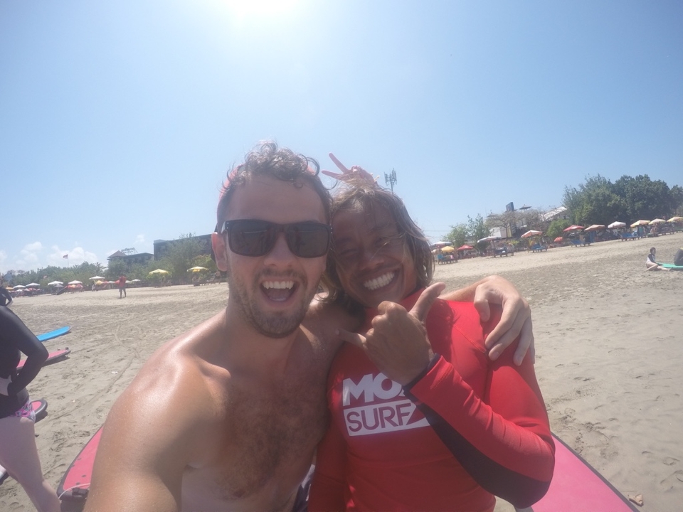 Selfie of two individuals on the beach.
