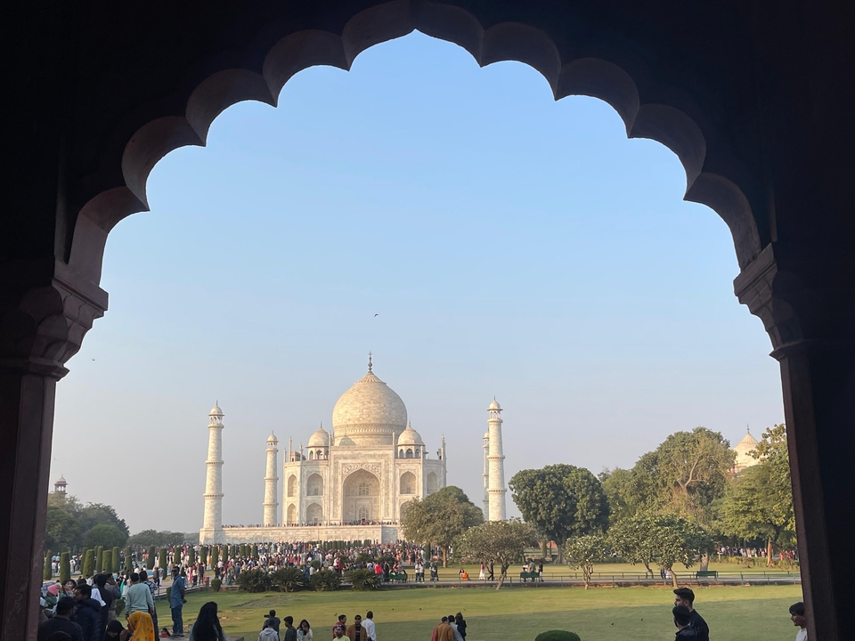 Une vue du Taj Mahal encadrée par une arche ornementée.