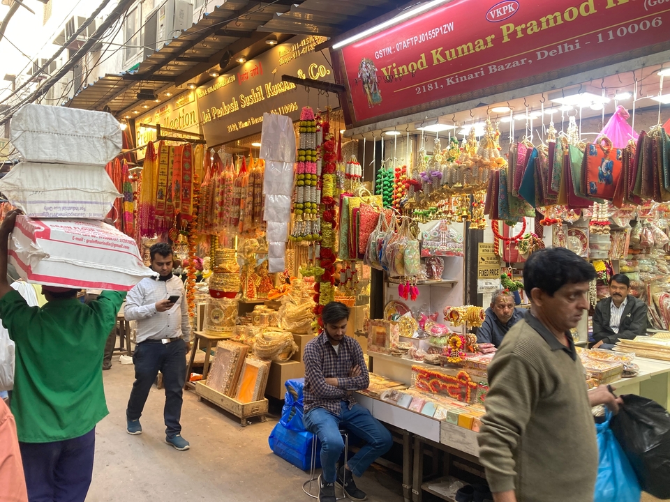 Colorful market scene with stalls and shoppers.