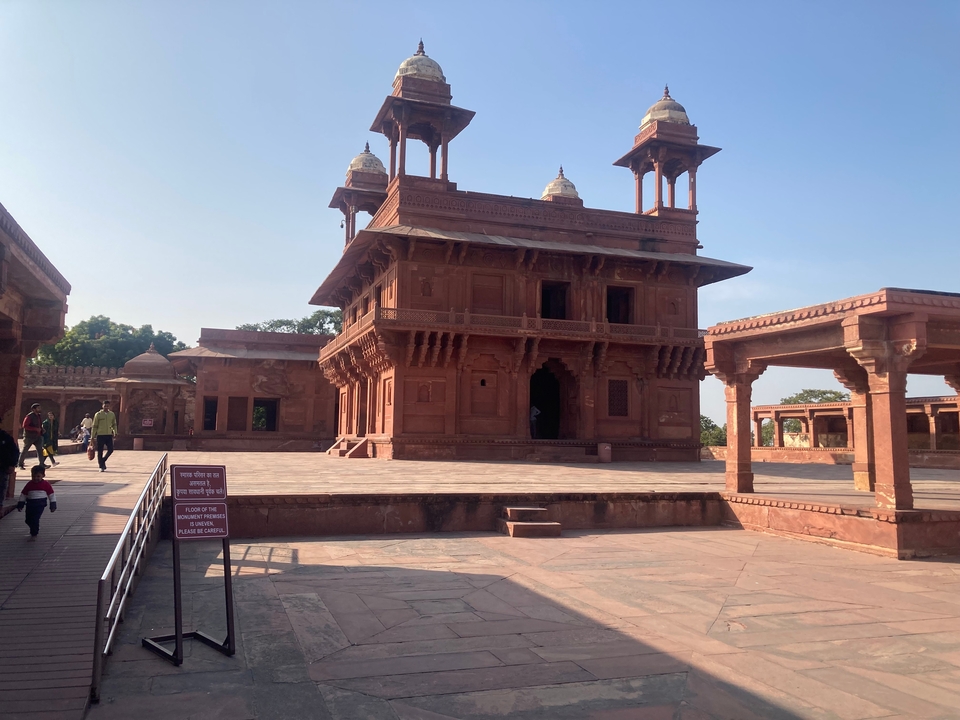 Historic red sandstone architecture with visitors.
