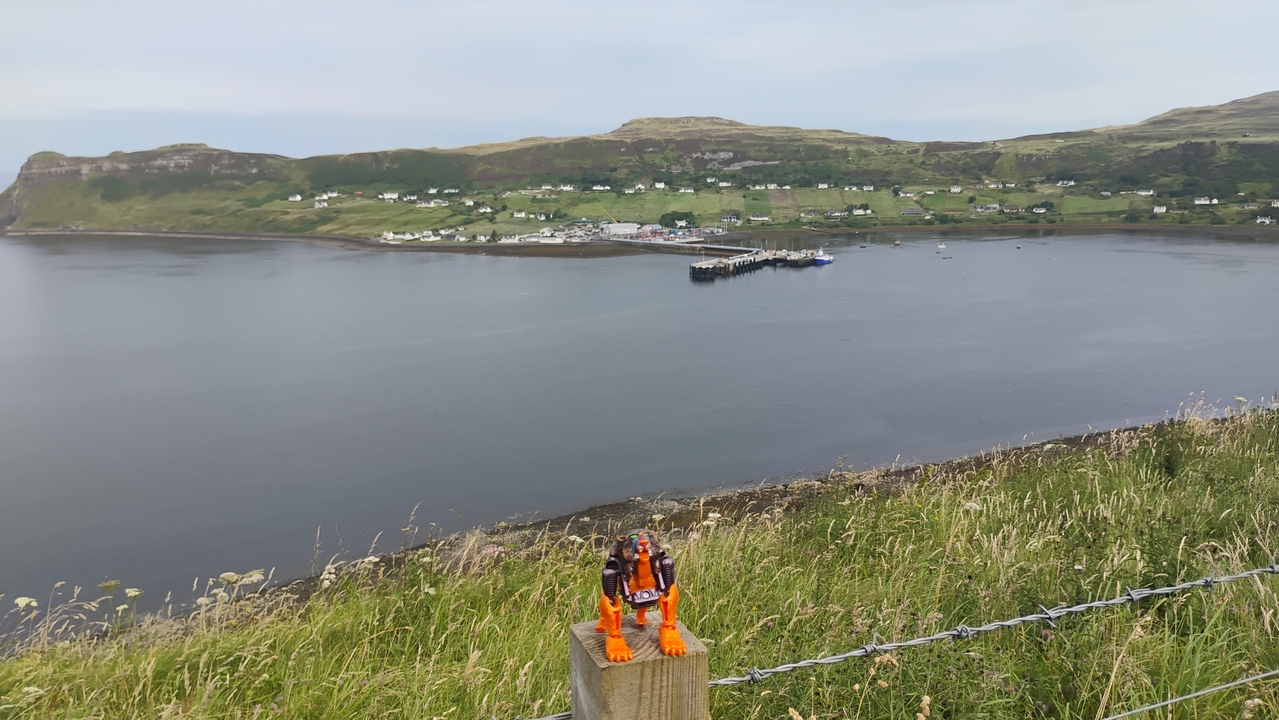 Toy figure with a view of houses by the waterfront.