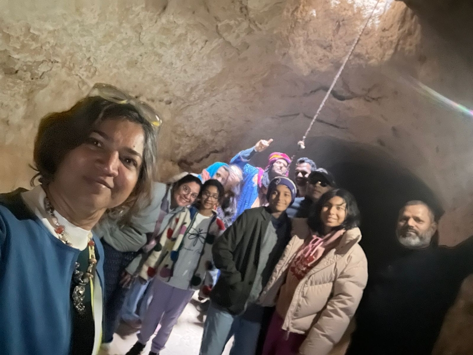 A group of people inside a dimly lit cave or tunnel.