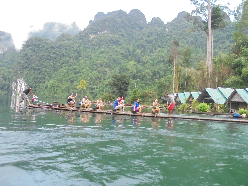 Group of people on a floating platform on a lake.